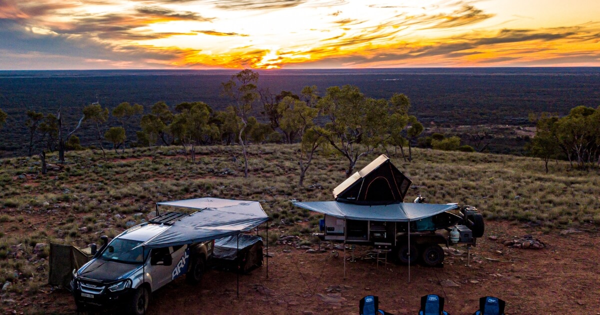 Camper trailer setup at sunset in Australian outback