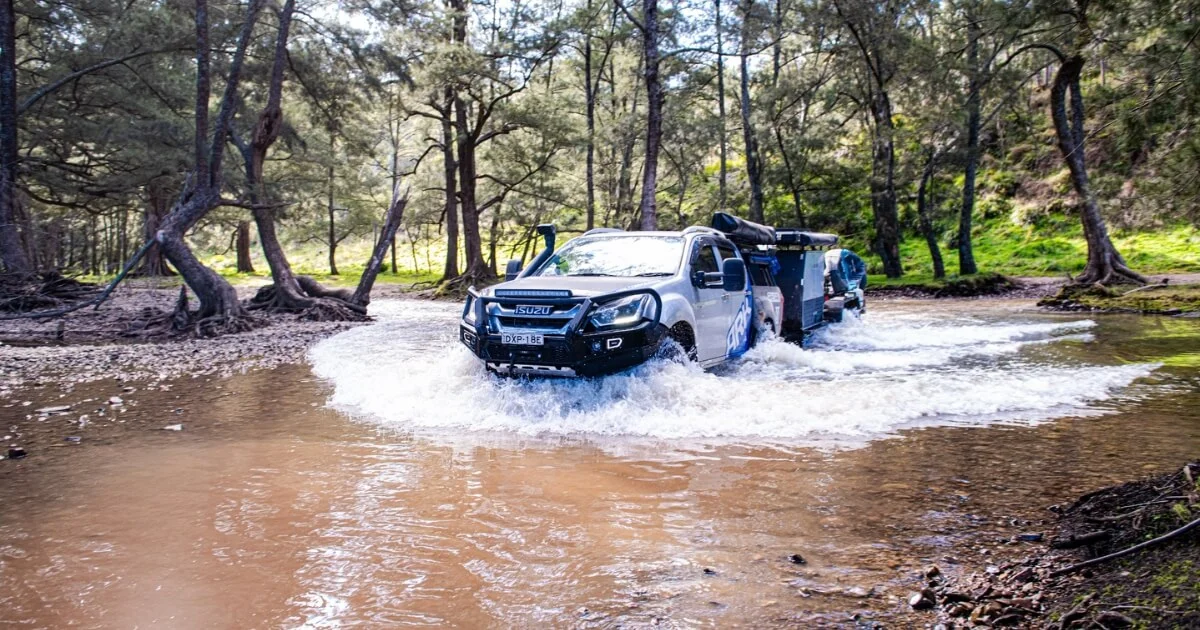 The Ark ute safely driving through a lake